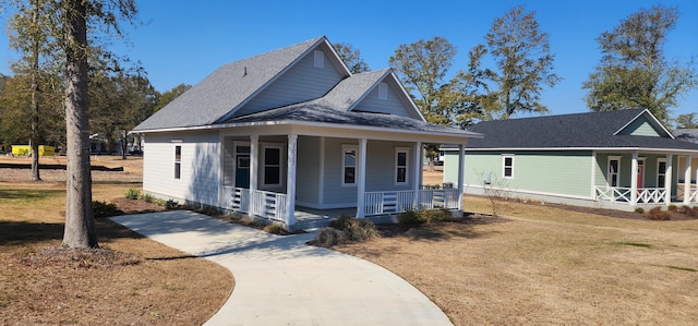 view of front of house with a porch and a front yard