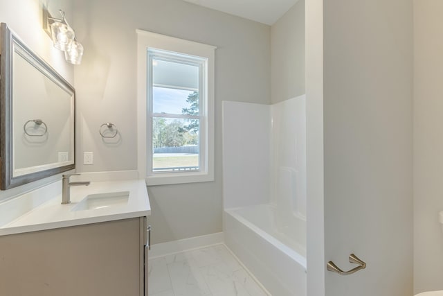 bathroom with shower / bath combination, marble finish floor, baseboards, and vanity