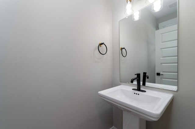 bathroom with visible vents and a sink