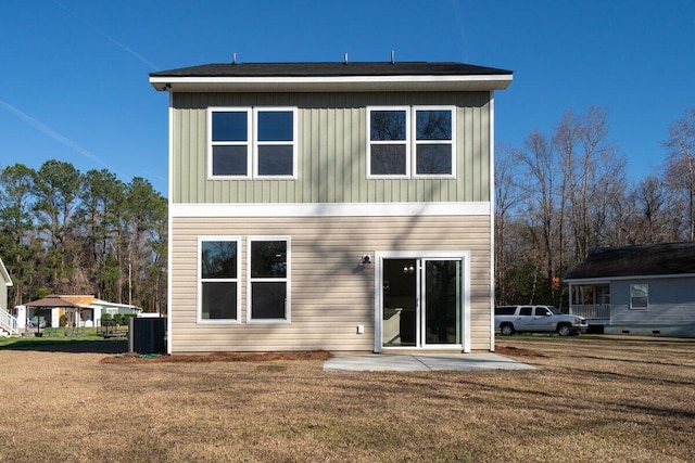 rear view of property featuring a patio area and a yard