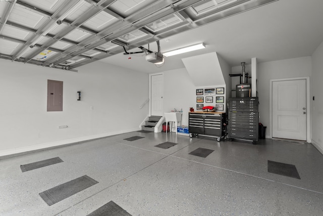 garage with baseboards, a garage door opener, a sink, and electric panel