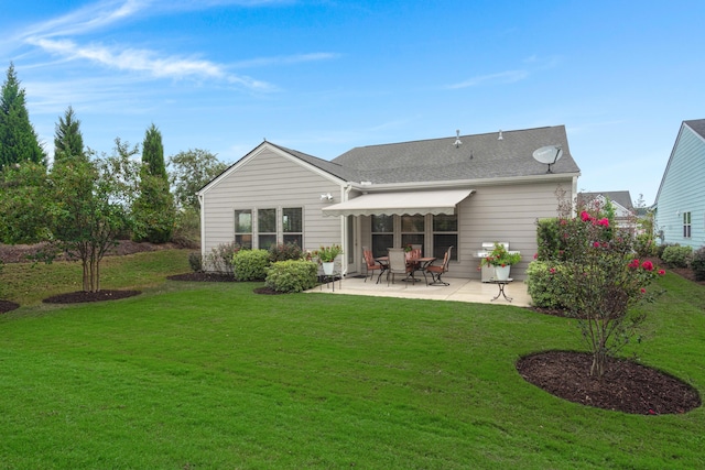rear view of property featuring a patio and a lawn