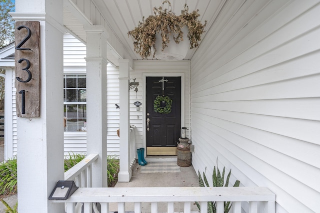 view of exterior entry with covered porch