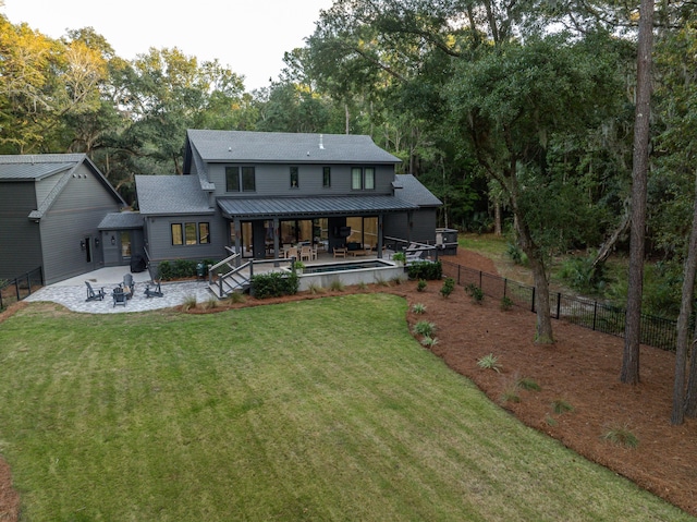 back of property featuring a patio area and a yard