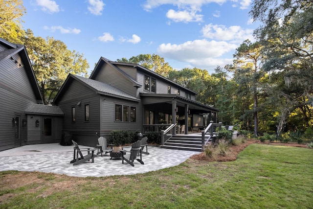 back of property with a lawn and a patio area