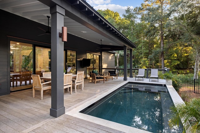 view of pool with ceiling fan and a wooden deck