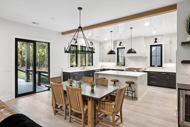 dining room with light wood-type flooring and beverage cooler