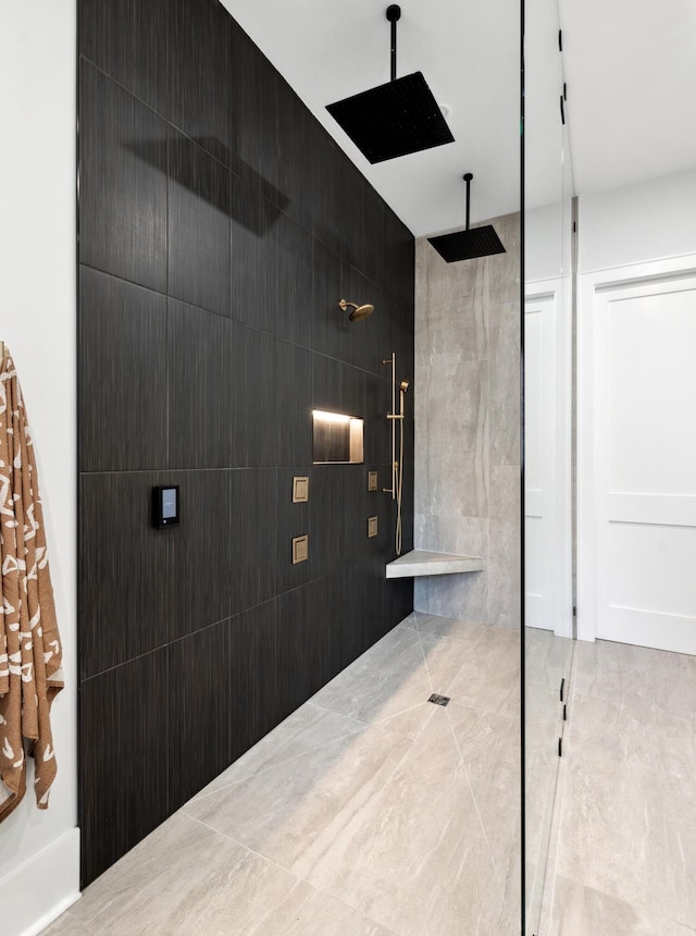 bathroom featuring a shower and tile walls