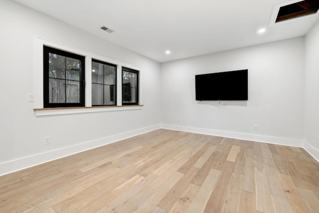 unfurnished room with light wood-type flooring