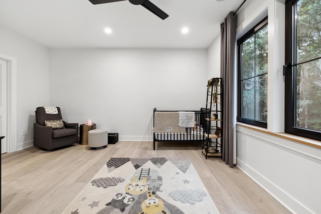 living area featuring light wood-type flooring and ceiling fan