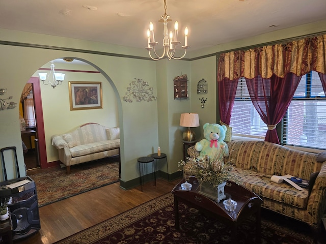 living room featuring a chandelier and wood-type flooring