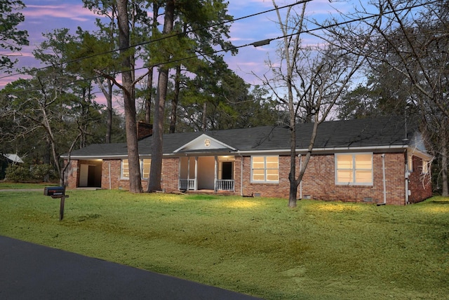 ranch-style home with crawl space, a front lawn, and brick siding