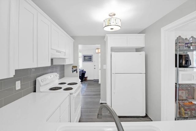 1514 Patterson Ave, Charleston, SC 29412 - kitchen featuring white appliances, under cabinet range hood, white cabinetry, backsplash, and light countertops