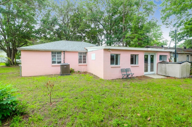 1514 Patterson Ave, Charleston, SC 29412 - back of property featuring french doors, concrete block siding, central AC unit, and a lawn
