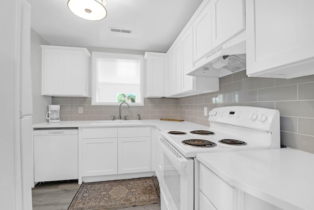 1514 Patterson Ave, Charleston, SC 29412 - kitchen featuring white appliances, under cabinet range hood, a sink, light countertops, and white cabinets