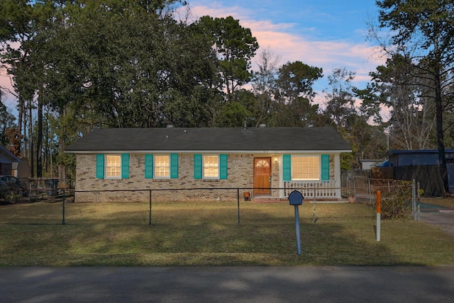 ranch-style home featuring a yard