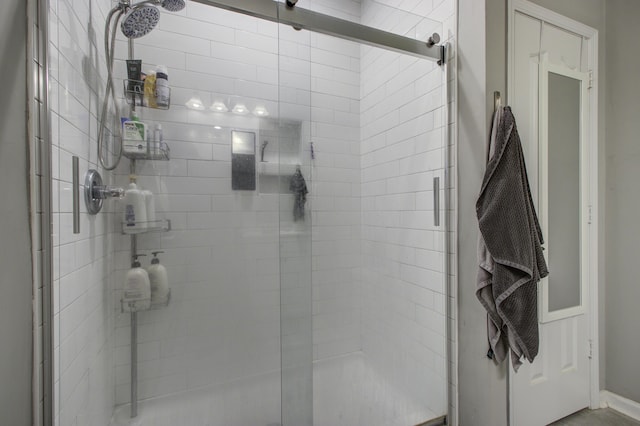 bathroom with a shower with door