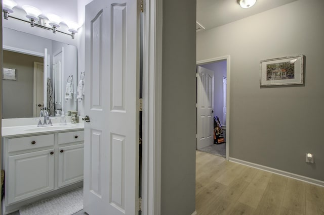 bathroom featuring vanity and wood-type flooring