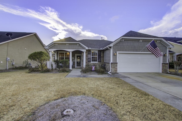 view of front of property featuring a garage and a front yard