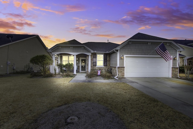 view of front of home featuring a garage and a yard