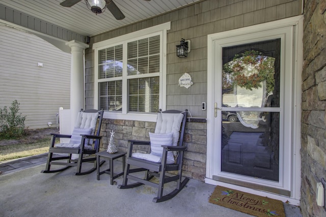 entrance to property featuring covered porch and ceiling fan