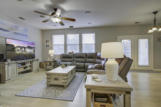 living room with ceiling fan and light wood-type flooring