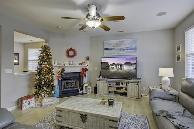 living room with ceiling fan and light hardwood / wood-style flooring