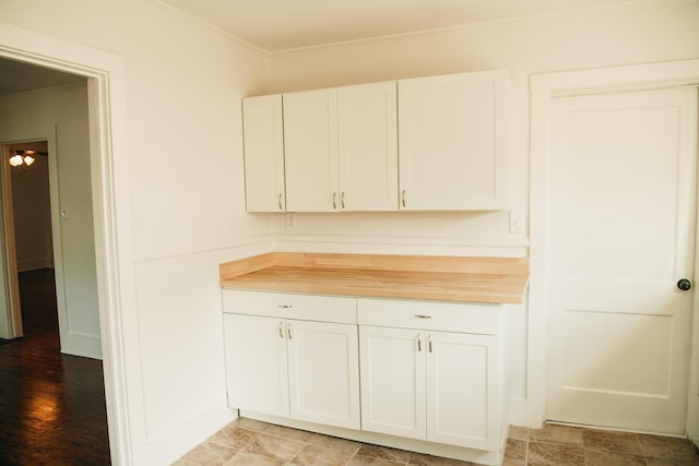 317 Bay St, Walterboro, SC 29488 - kitchen with white cabinets, ornamental molding, and wood counters