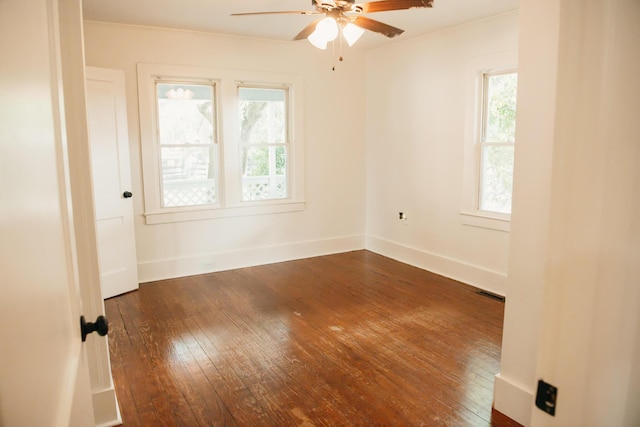 317 Bay St, Walterboro, SC 29488 - unfurnished room featuring dark wood-type flooring, healthy amount of natural light, and a ceiling fan