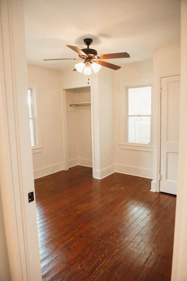317 Bay St, Walterboro, SC 29488 - unfurnished bedroom with dark wood-type flooring, multiple windows, and a closet