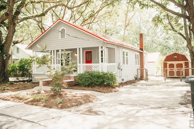 317 Bay St, Walterboro, SC 29488 - view of front of property featuring covered porch, a storage unit, a chimney, and crawl space