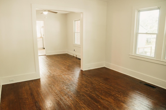 317 Bay St, Walterboro, SC 29488 - empty room featuring dark wood-style flooring, healthy amount of natural light, and ceiling fan