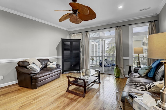 living room featuring light wood-type flooring, ceiling fan, and ornamental molding