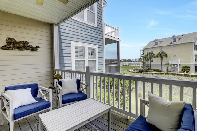 wooden deck featuring ceiling fan