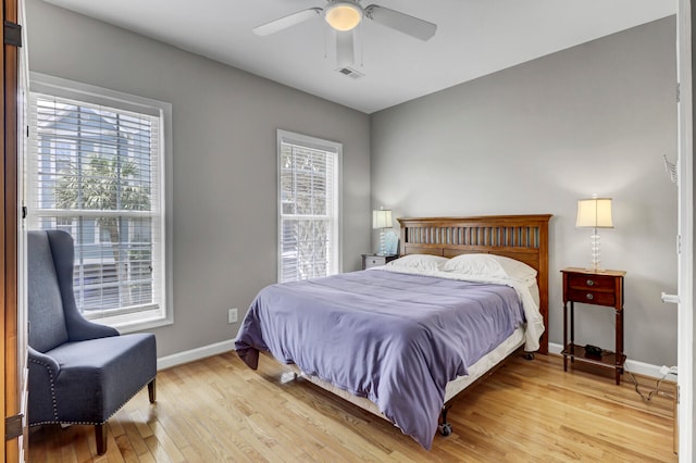 bedroom with ceiling fan and light hardwood / wood-style floors