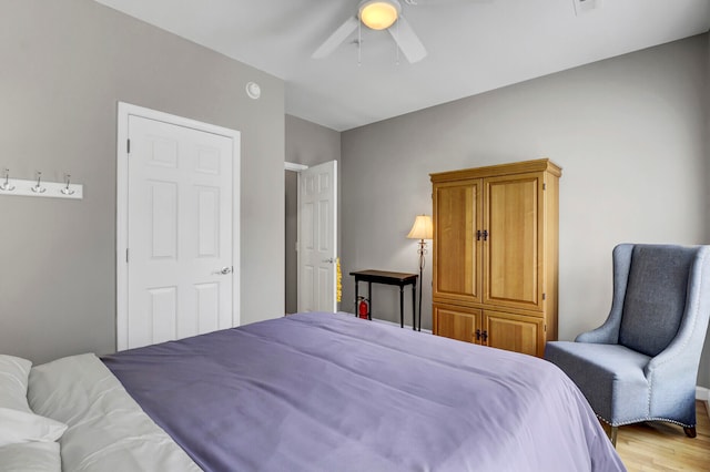 bedroom with ceiling fan and wood-type flooring