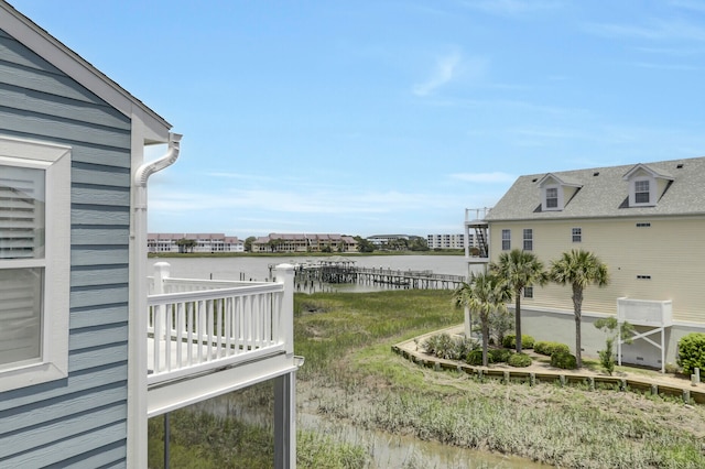 view of yard featuring a balcony and a water view