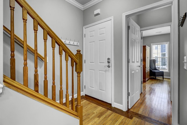 foyer featuring hardwood / wood-style flooring and ornamental molding