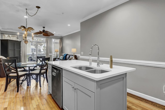 kitchen featuring stainless steel dishwasher, ornamental molding, a kitchen island with sink, sink, and light hardwood / wood-style flooring