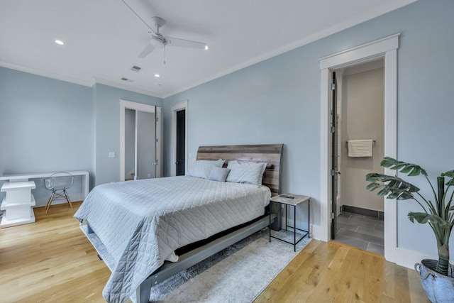 bedroom with hardwood / wood-style floors, ceiling fan, and ornamental molding