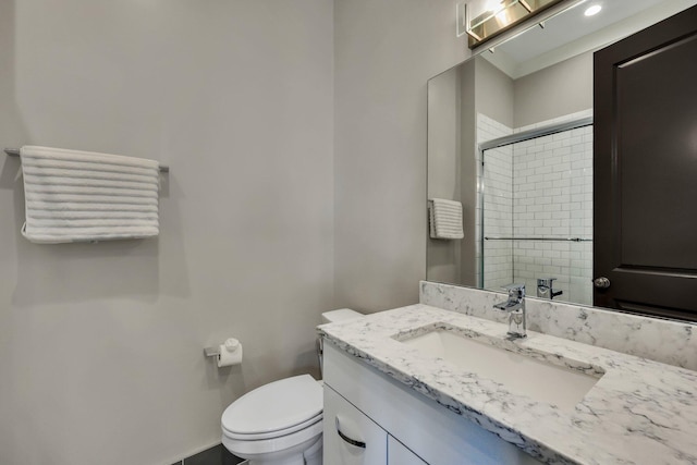 bathroom with vanity, toilet, and walk in shower