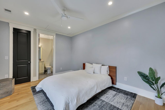 bedroom with light hardwood / wood-style floors, ceiling fan, and ensuite bathroom