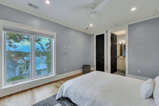 bedroom featuring connected bathroom, ceiling fan, and hardwood / wood-style floors