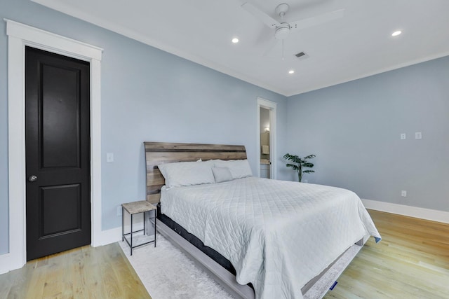 bedroom with ceiling fan and light hardwood / wood-style floors