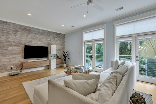 living room with a healthy amount of sunlight, french doors, and light hardwood / wood-style flooring