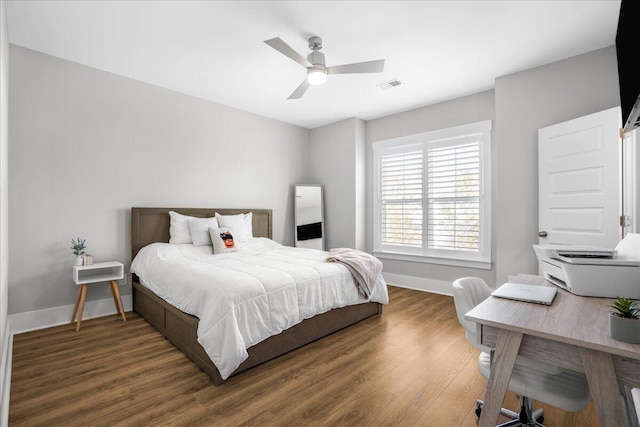 bedroom with dark hardwood / wood-style flooring and ceiling fan