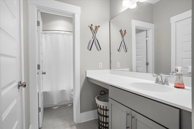 full bathroom featuring vanity, shower / bathtub combination with curtain, toilet, and tile patterned floors