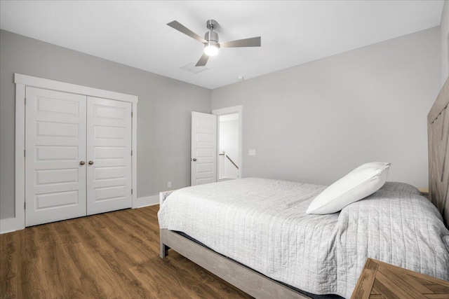 bedroom featuring dark wood-type flooring, a closet, and ceiling fan