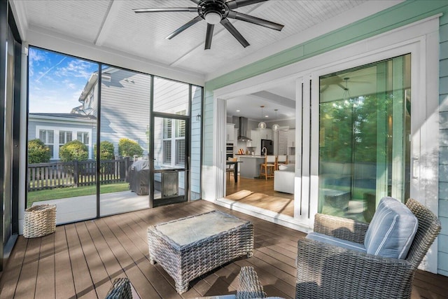 sunroom featuring ceiling fan