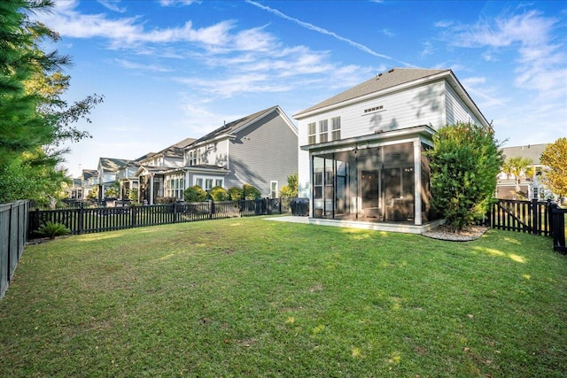 back of property featuring a lawn and a sunroom